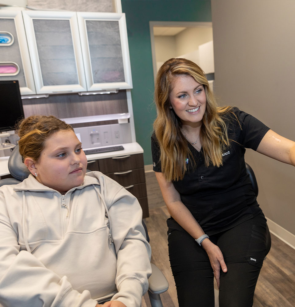 staff member showing patient dental treatment information