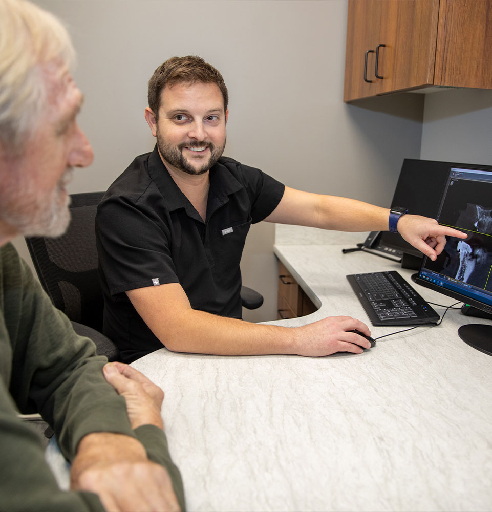 doctor and patient going over dental treatment information within the dental center