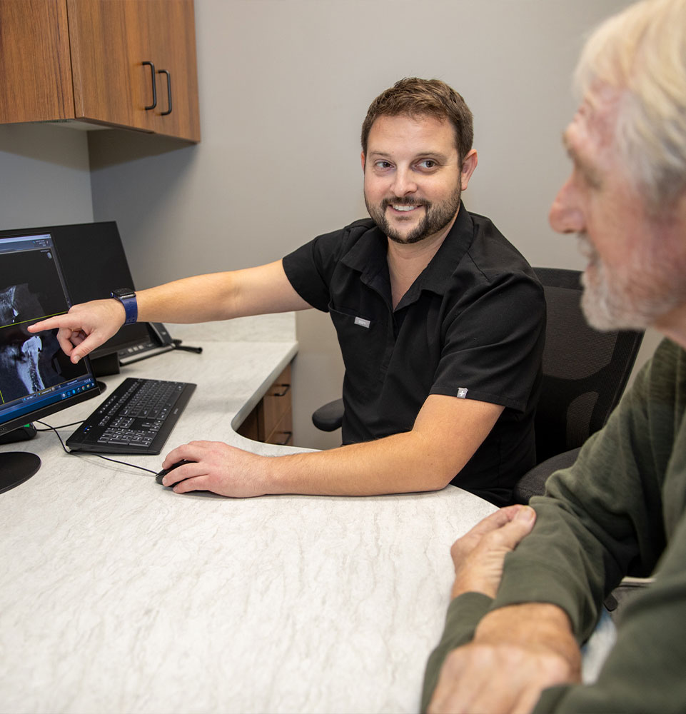 doctor going over dental treatment information with patient