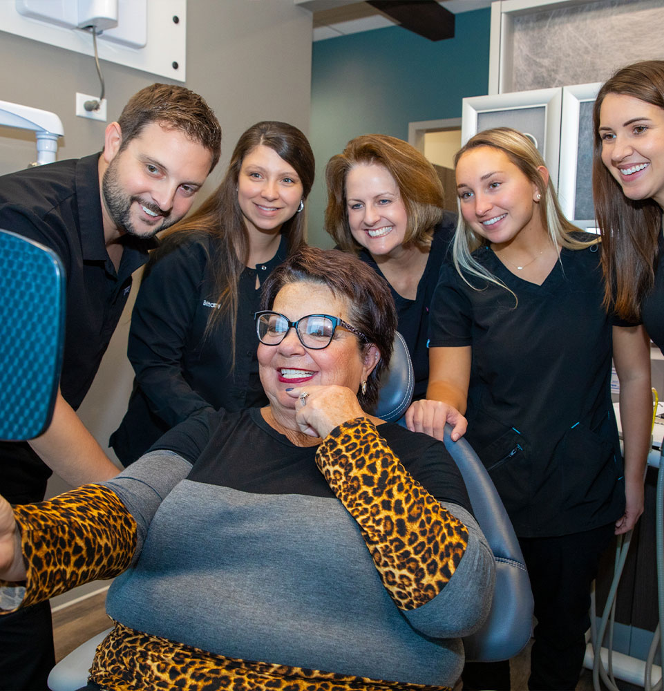 Patient smiling brightly after their dental treatment within the dental center