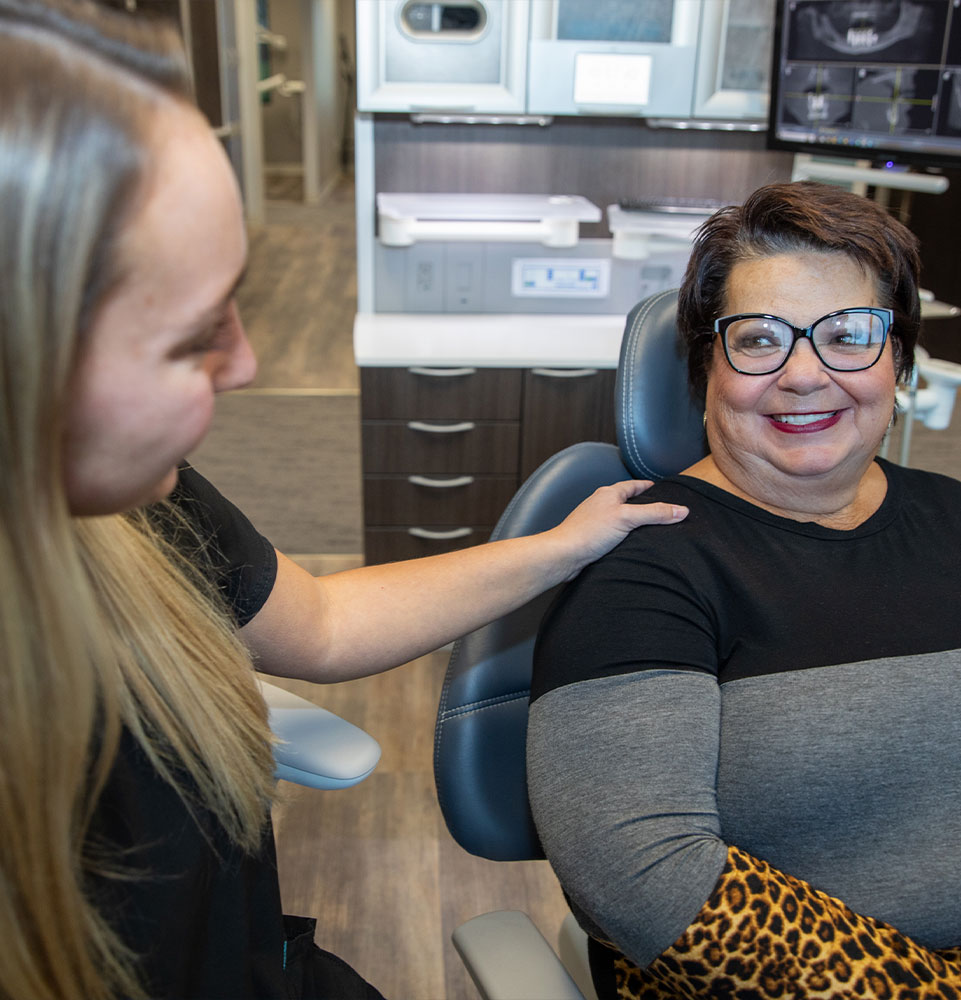 patient being helped with staff member inside of the dental center