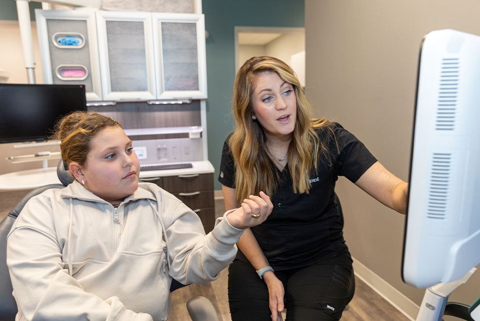 patient and staff member going over dental treatment information